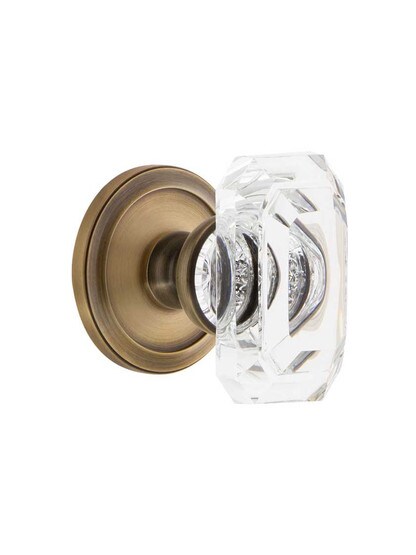 Grandeur Circulaire Rosette Door Set with Clear Crystal-Glass Baguette Knobs in Antique Brass.